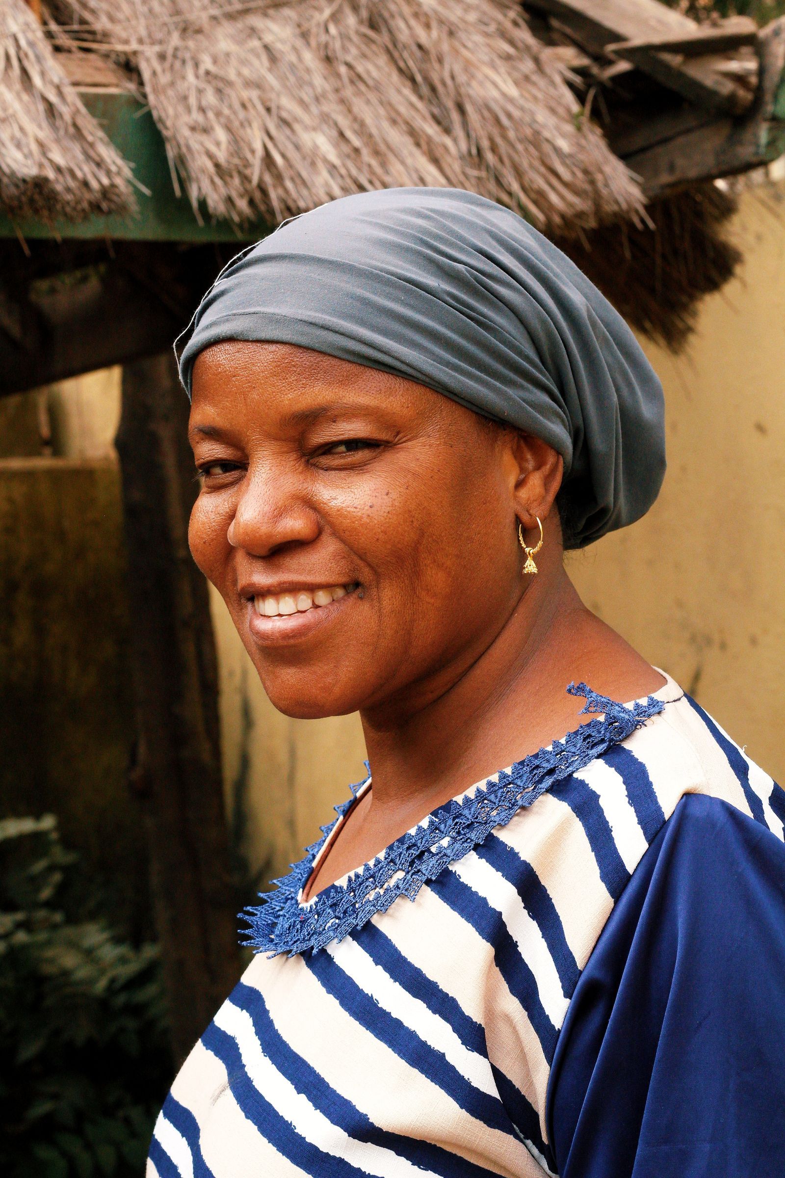 A woman in a red headscarf smiling